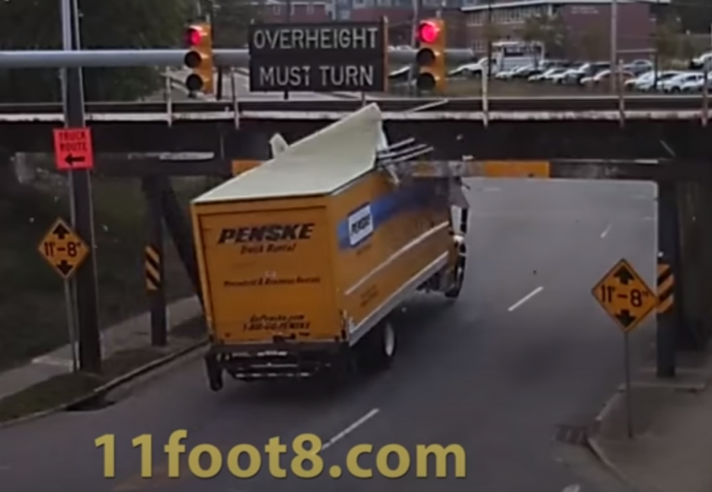 Penske rental truck smashed under low bridge.